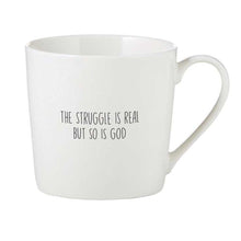Load image into Gallery viewer, White mug with text 'The struggle is real but so is God' on a white background